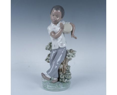 Glossy figure of a young man by a shrub feeling the rhythm. Lladro backstamp. This item has its original box (7.5"L x 5.75"W 