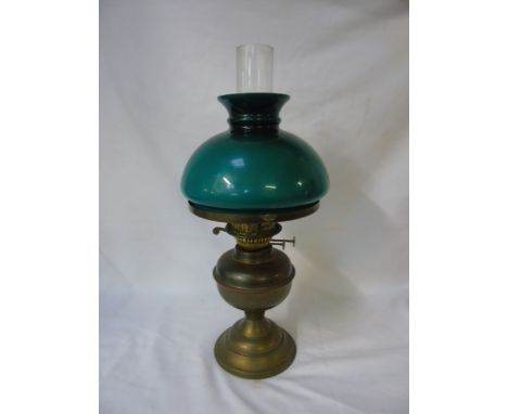 BRASS OIL LAMP WITH A GREEN GLASS SHADE