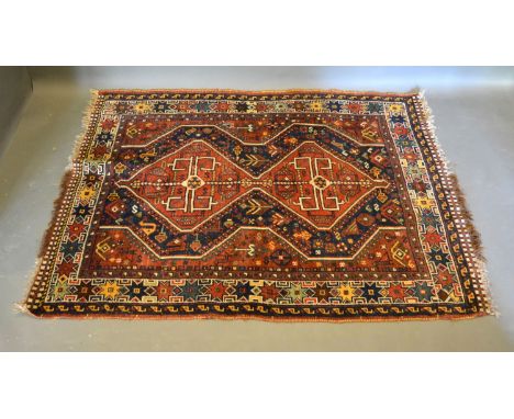 A North West Persian woollen rug with two central medallions within an all over design within multiple borders, 163cms x 117c