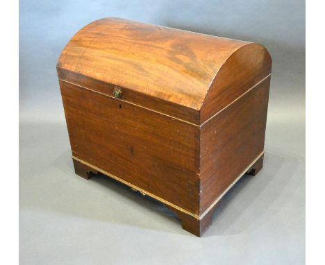 A 19th Century Mahogany Cellarette, the hinged domed  top enclosing a sectional interior raised upon bracket feet, 52 cms wid