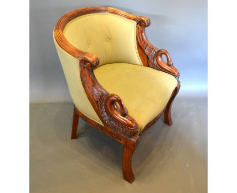 A French Empire Style Mahogany Armchair, the reeded and button upholstered back above scroll arms carved with swans, raised u