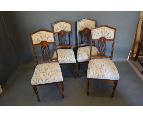 A set of four Edwardian inlaid drawing room chairs together with a harlequin set of seven Chippendale style dining chairs and