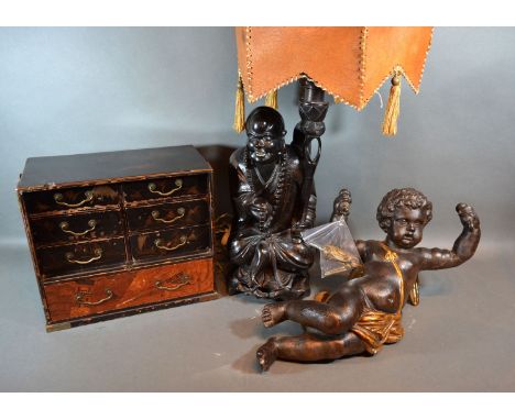 A 20th century painted light fitting in the form of Putti together with a figural table lamp and a table cabinet. 