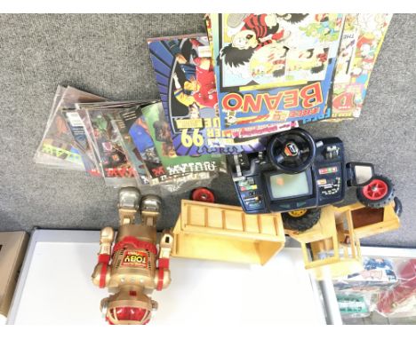 A box Containing a Wooden Tractor. A Walking talking Robot. A retro Racing Game and a Collection of Various Comics..