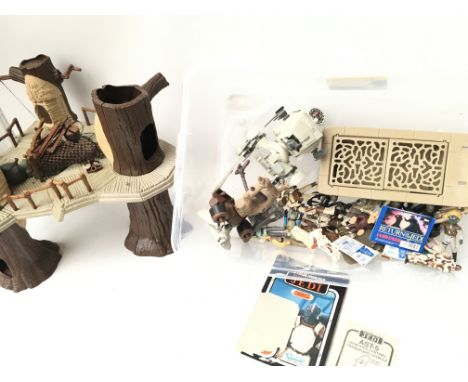 A Collection of Vintage Star Wars Figures Vehicles and Parts. Also an Ewok Village.