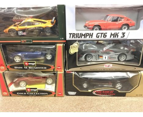 A Collection of 6 X 1:18 scale Boxed Die-cast Vehicles including a Sun Star Triumph GT6 MK3. A Burago BMW M Roadster. A UT Mo