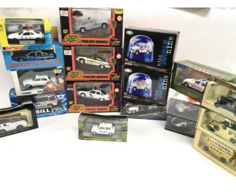 A Collection of Various boxed Die-Cast Police Cars including Corgi. road Champs etc.