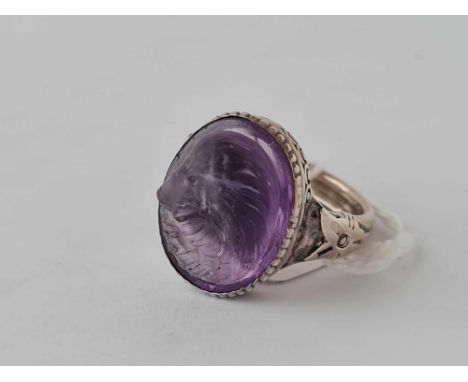 A vintage carved amethyst dog head set in silver ring size R  