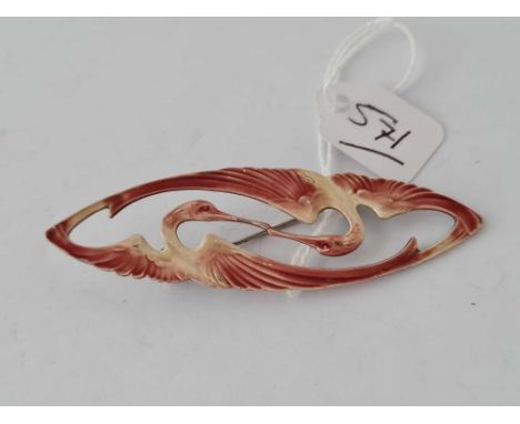A oval metal and coloured enamel brooch of two winged birds