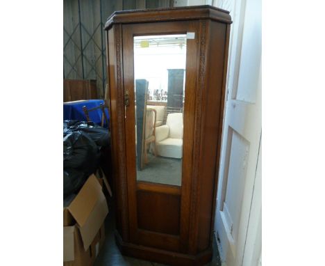 A vintage oak corner wardrobe, with mirrored door,