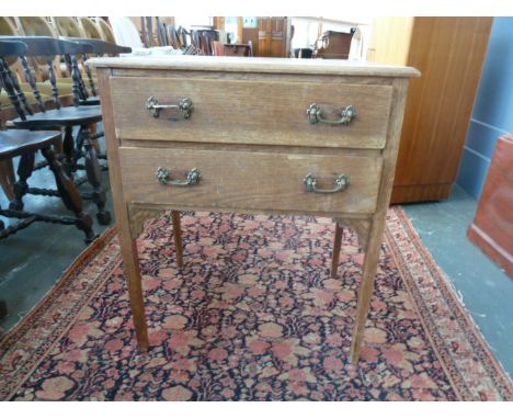 An oak side table, square top over two drawers with interal desk, on square legs, 60cmW x 45cmD x 70cmH