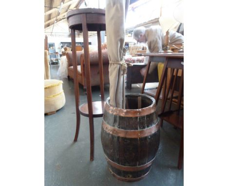 An early 20th century mahogany circular pot stand with undershelf, with a copper bound barrel, a set of bellows, and a vintag