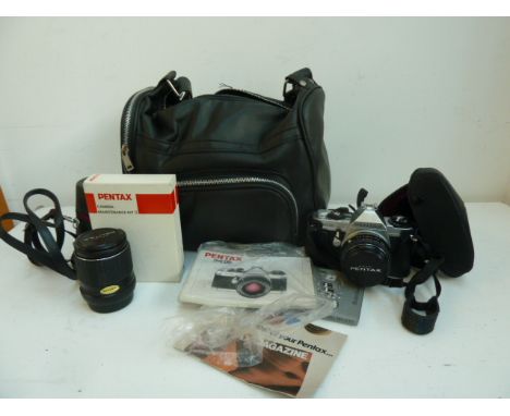 A Pentax MG 35mm camera with Pentax-M 1:2 50mm lens and carry case, instruction manual, spare Pentax-M 1:3.5 135mm lens and c