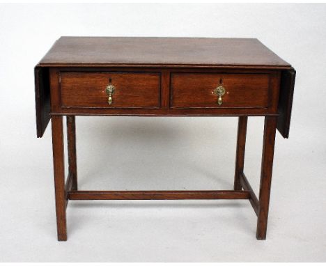 An oak drop flap clerks desk, rectangular top over two short drawers with brass drop handles, raised on square section legs w