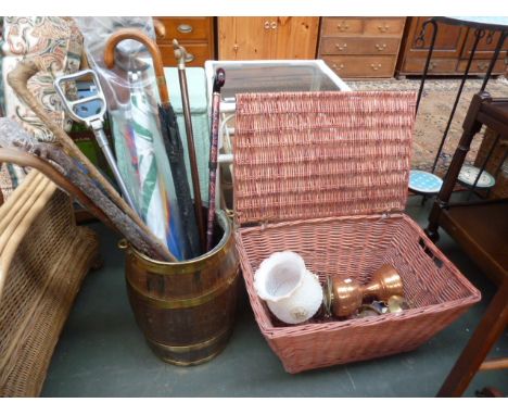 A vintage oak and brass bound barrel with several walking sticks and umbrellas, with a wicker hamper and three vintage lamps