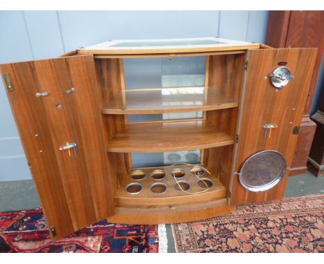 A Turnidge 1960's/70's mobile bow-fronted cocktail cabinet fitted with two doors, two sliding glass doors, two internal shelv