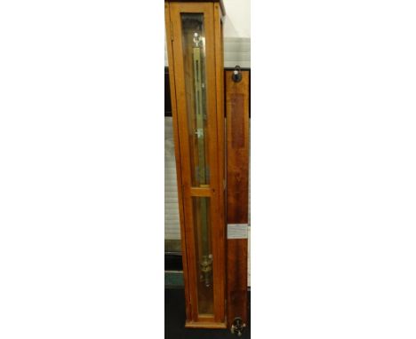 An industrial ship's type brass barometer, of rectangular form, in an oak case, 126cm high, 19cm wide, 14cm deep, a barometer