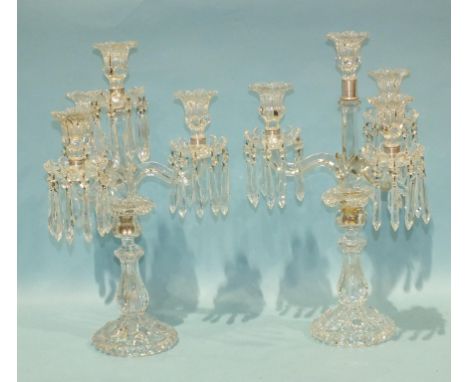 A pair of modern moulded glass three-branch four-light candelabra, 48cm high, (one with centre drip pan lacking), (2).