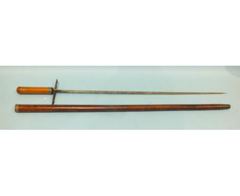 A 19th century sword stick, the scroll-etched 70cm blade marked 'Toledo', with Malacca halt and cover, sprung quillon to eith