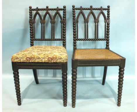 A harlequin set of ten Gothic-style ebonised bobbin-turned dining chairs with pierced Gothic arch backs, six with drop-in sea