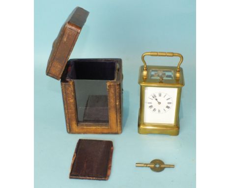 A late-19th/early-20th century brass repeating carriage clock in travelling case, with key, 14cm high, (damage to enamel dial