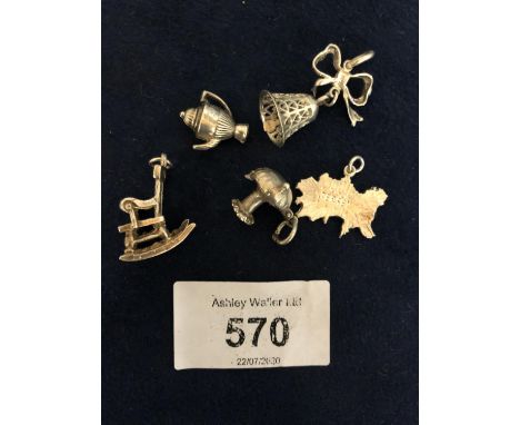 FIVE SILVER CHARMS TO INCLUDE ROCKING HORSE, ISLE OF JERSEY, MUSHROOM HOUSE ETC 