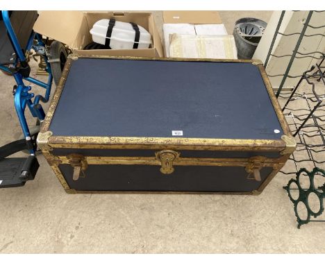 A VINTAGE METAL BOUND TRAVEL TRUNK 