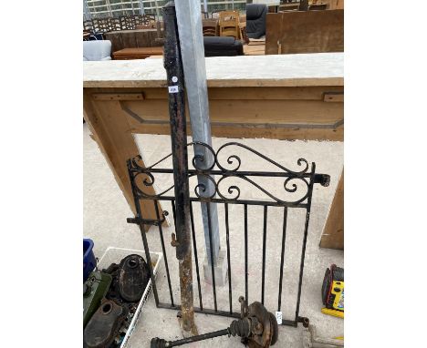 A WROUGHT IRON GATE AND POST 