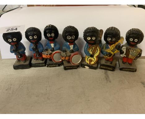 A VINTAGE SET OF SEVEN ROBERTSON'S MARMALADE FIGURES PLAYING MUSICAL INSTRUMENTS 
