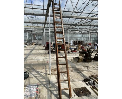A TWO SECTION 30 RUNG WOODEN LADDER 