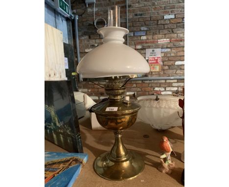 A VINTAGE BRASS OIL LAMP WITH WHITE GLASS SHADE 