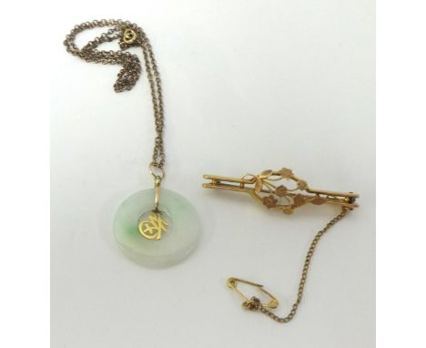 A Jade pendant and chain and a 9ct gold antique brooch.
