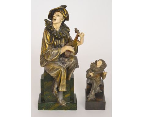 A replica Art Deco figure of a perriot singing and playing a lute and another similar small figure (2)