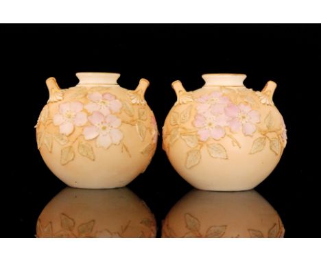 A pair of Grainger, Worcester Royal China Works vases of ovoid form with twin handles and a squat flared neck, each decorated