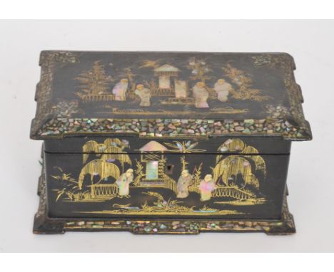 A 19th Century laquered papier mache tea caddy inlaid with mother of pearl figures in garden scenes, width 26cm