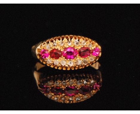 An early 20th Century 18ct hallmarked ruby and diamond ring five oval rubies within a fourteen stone diamond set border, Ches