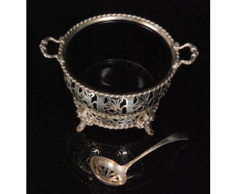 A hallmarked silver twin handled sugar basin of circular outline with pierced panel decoration and gadrooned rim, blue glass 