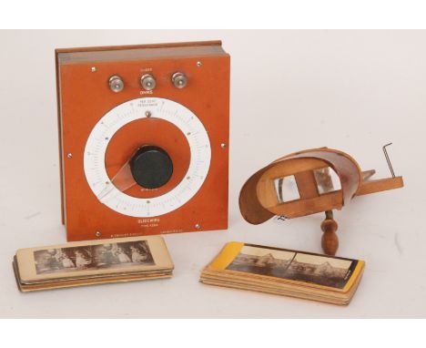 An Edwardian mahogany stereoscopic viewer with various views and social history cards, together with a Galvanometer by W.G.Py