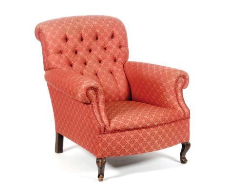 An early 20th Century button back armchair with roll arms, upholstered in acanthus patterned deep pink fabric over foliate ca