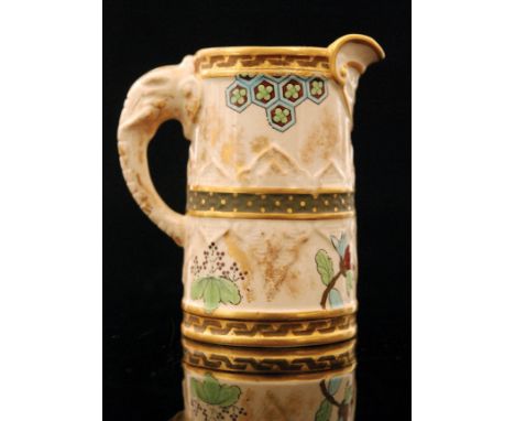 A Royal Worcester Aesthetic cream jug decorated with gilt and enamel patterned banding, sprigs of flowers and foliage and tes