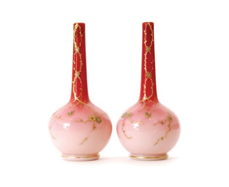 A pair of late 19th Century peach bloom vases, possibly Harrach, of globe and shaft form decorated with relief gilded boughs 