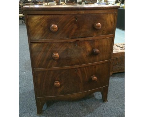 A George III mahogany bowfront chest of three graduated drawers, turned wood handles on splayed bracket feet, width 76cm