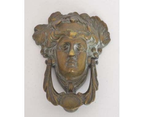 A brass Art Nouveau style door knocker in the form of a maiden wearing a fruiting vine headdress, height 17cm