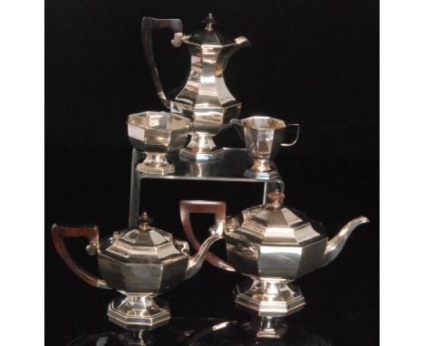 An Art Deco silver plated octagonal pedestal five piece tea set terminating in rosewood arched loop handle and button finials