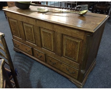 A Northern Counties style oak and mahogany crossbanded mule chest, the hinged top over a fielded quadruple panelled front and