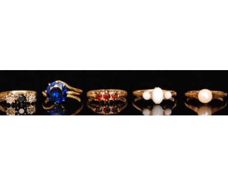 Five 18ct and 9ct mid 20th Century stone set rings to include a sapphire and diamond and an opal example. (5). 