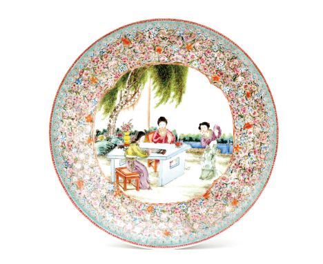 A large Chinese charger decorated to the central roundel with a scene of three women sat at a table and dancing in a garden s