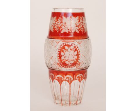 An early 20th Century Bohemian glass vase of swollen cylindrical form with a central diamond cut band, the whole ruby painted