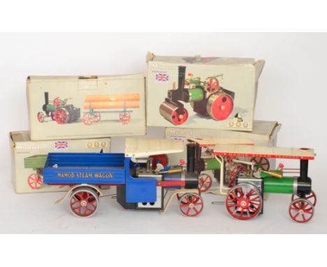 A Mamod live steam roller and a steam tractor with a lumber and an open wagon, all boxed, together with a steam wagon in blue