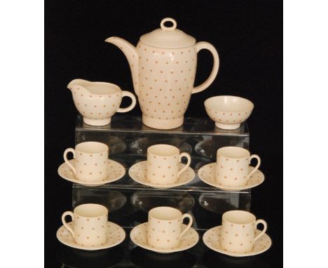 A Susie Cooper Falcon shape coffee set decorated in the 1688 Starburst pattern comprising coffee pot, six cans and saucers, m